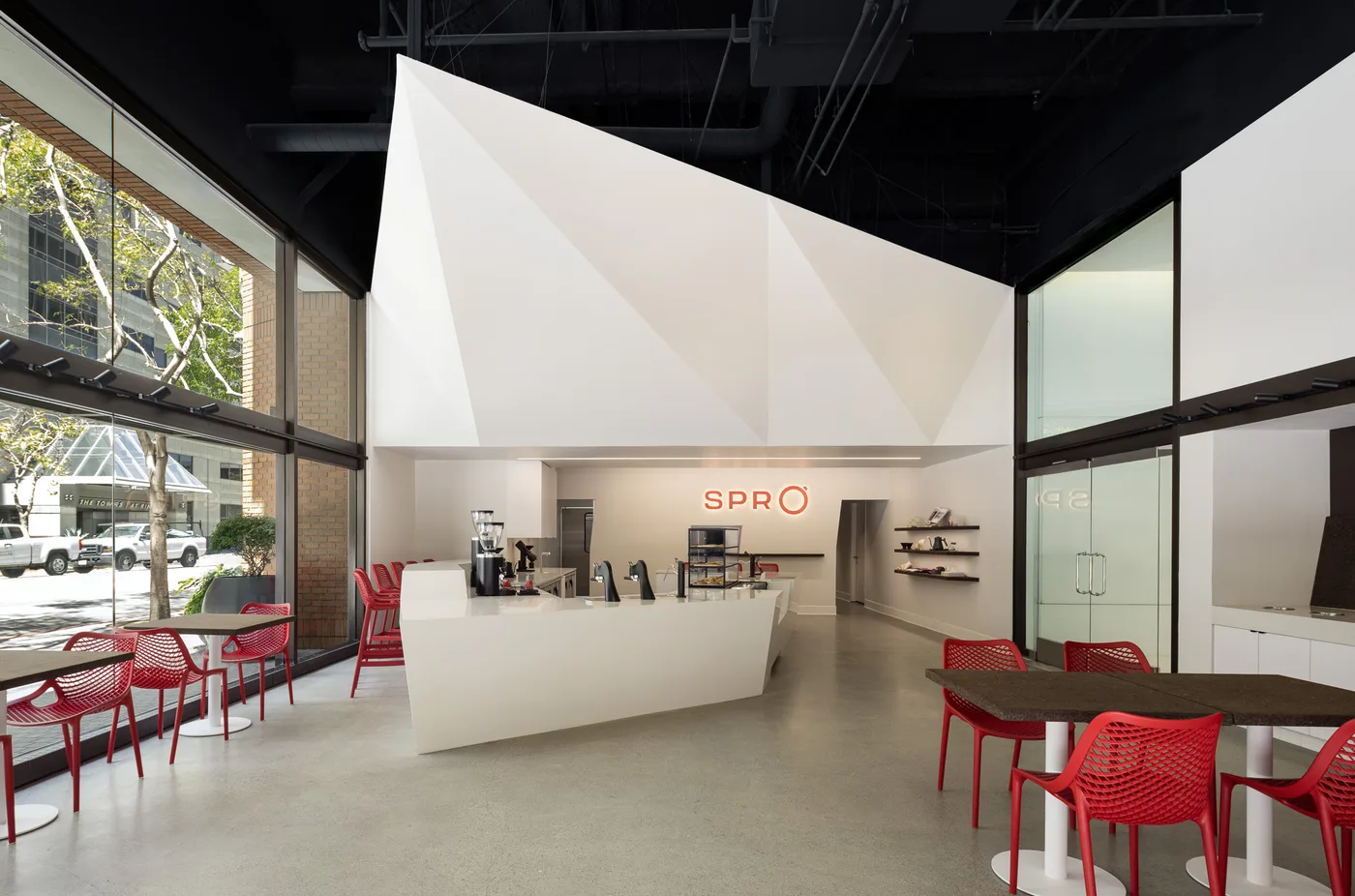 Spro Coffee Lab counter and ceiling geometry viewed from the street glass